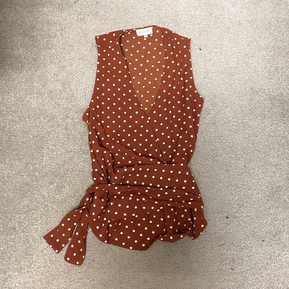 Polka dot sleeveless wrap blouse
